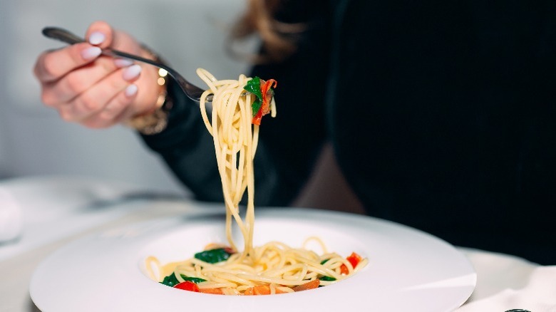 Woman eating pasta