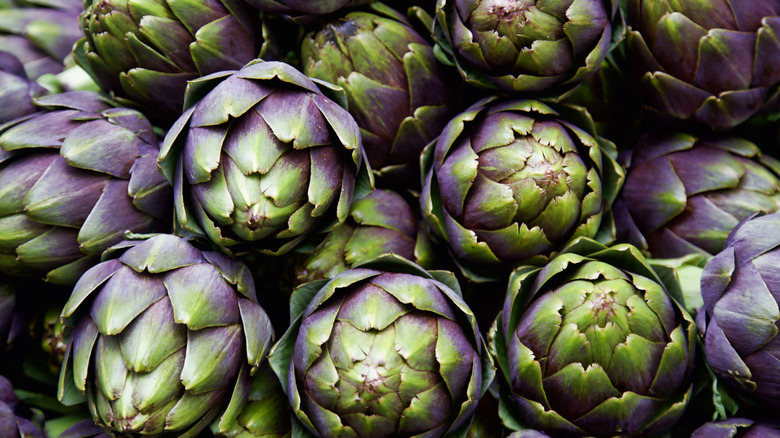 Purple and green artichokes stacked