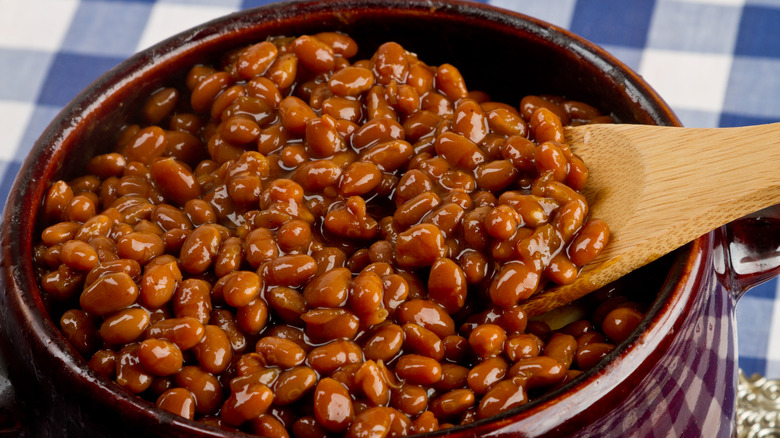 Crock of baked beans with spoon