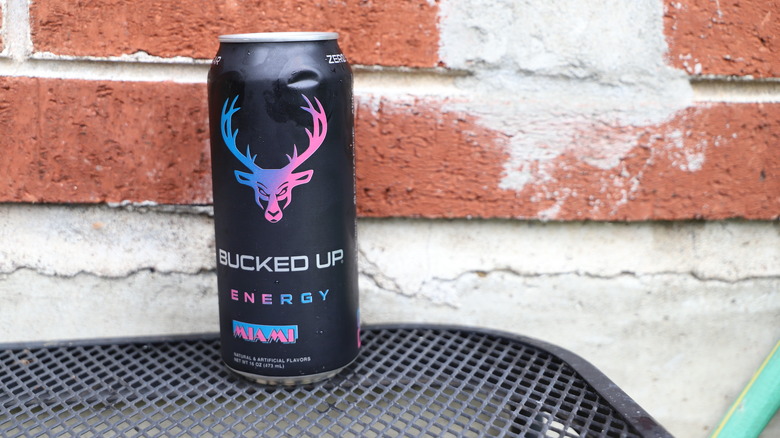 Can of Bucked Up Energy against brick wall