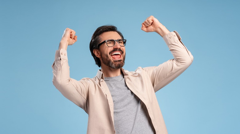 Triumphant man with beard