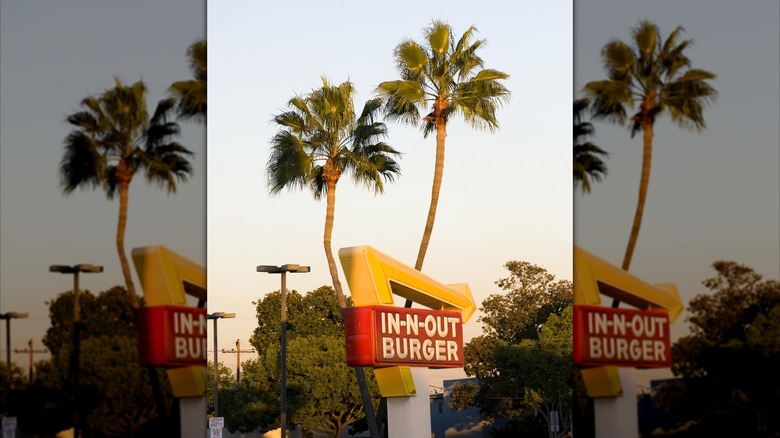 Crossed palm trees at an In-N-Out location