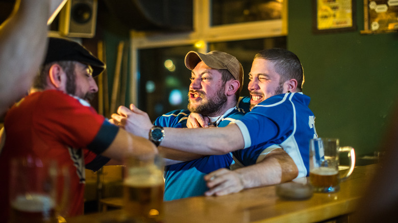 Men arguing over sports in a pub