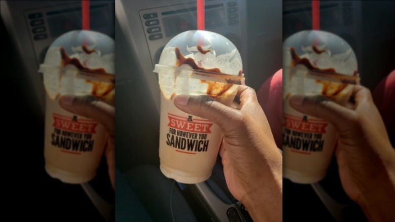 Hand holding Arby's Jamocha Shake