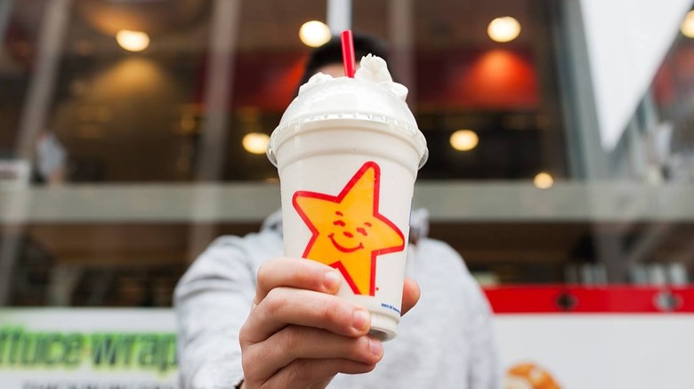 Person holding Carl's Jr. shake