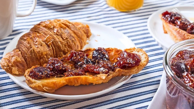 Croissant covered in red jam