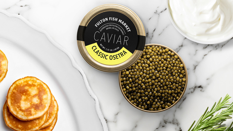 Tin of caviar with crème fraîche and blinis