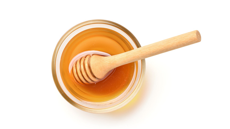 Natural honey and honey dipper
