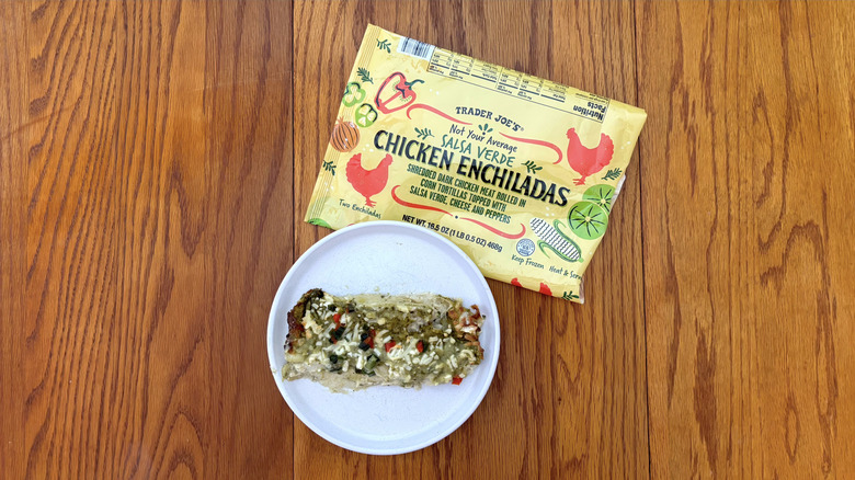 Trader Joe's salsa verde chicken enchiladas on white plate on wooden table