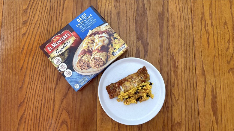 El Monterey beef enchiladas with spanish rice on white plate on wooden table