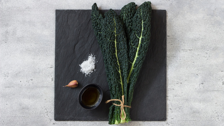 kale, salt, and olive oil on a slate board