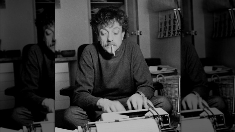 Black and white portrait of Kurt Vonnegut sitting at typewriter