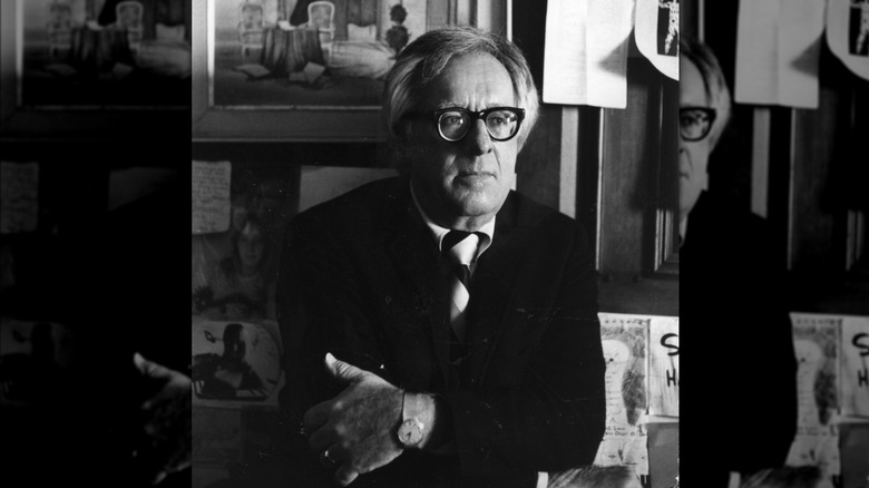 Black and white portrait of Ray Bradbury sitting with arms folded across chest