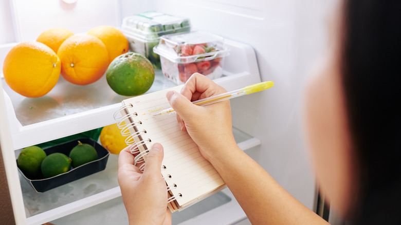 Woman making grocery list