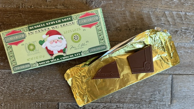 Russell Stover money candy opened up on wooden surface