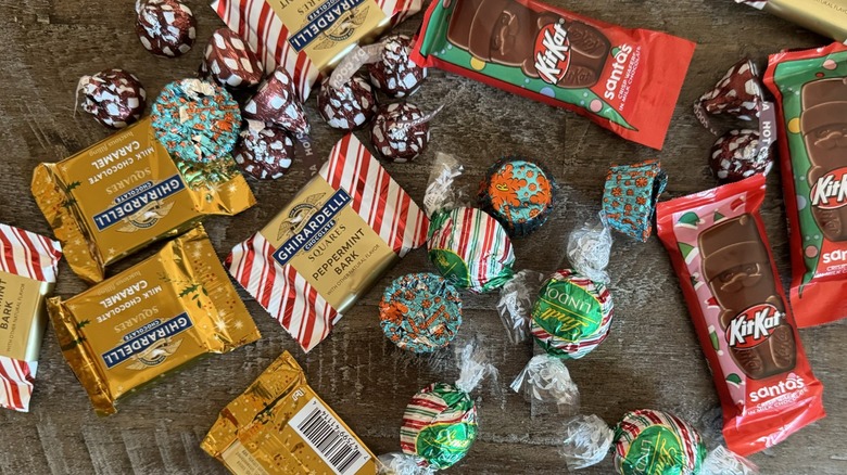 Assorted holiday candies on wooden table