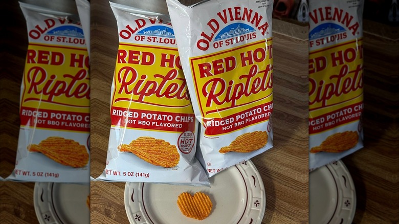 Two bags of Red Hot Riplets with a chip on a plate