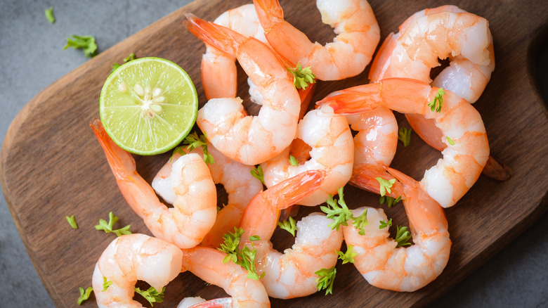 Cooked shrimp on brown board 