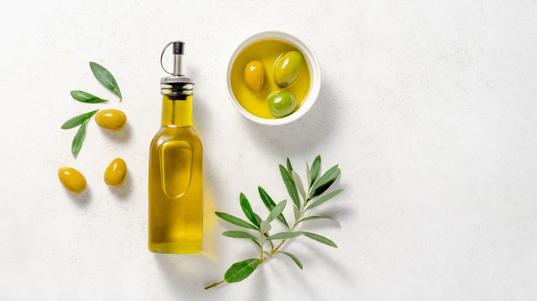 Olive oil bottle with olives