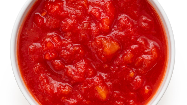 Canned tomatoes on white background