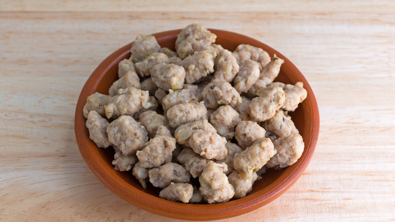 Crumbled sausage on brown plate