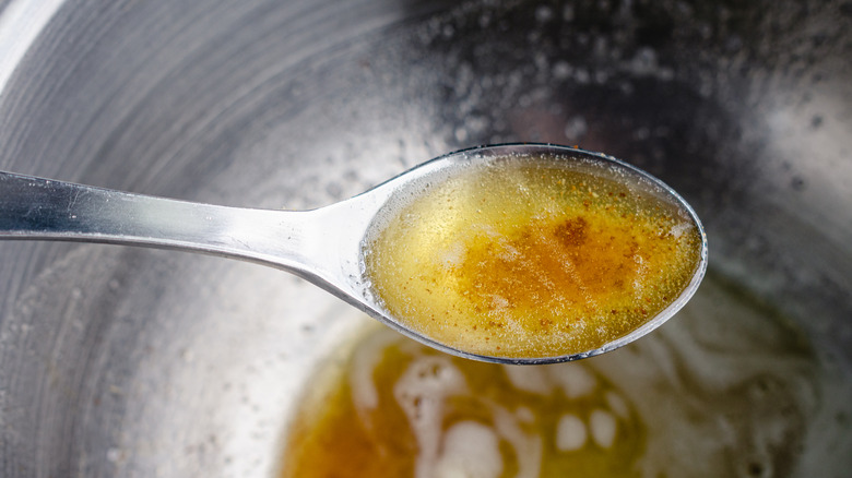 Brown butter in metal spoon