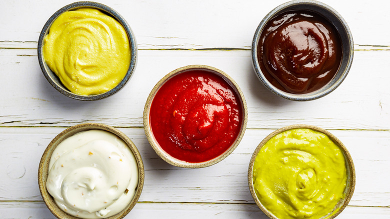 Assorted sauces on white wood