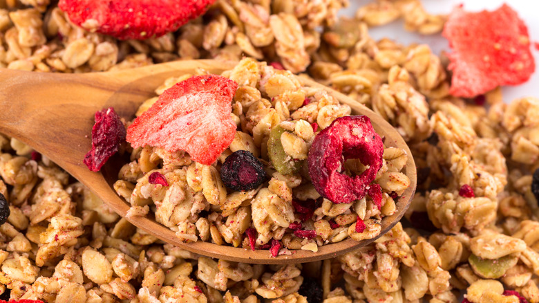 granola in a wooden spoon