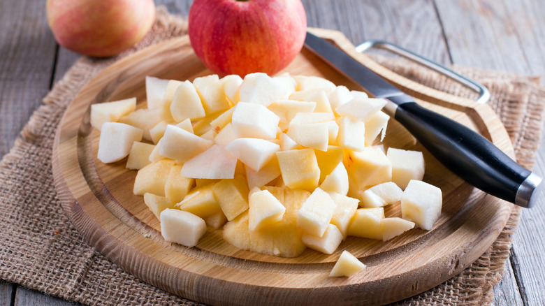 Chopped apple on wooden cutting board