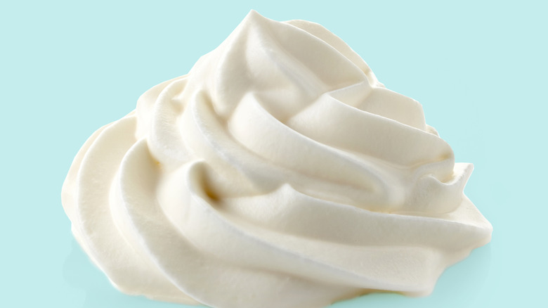 Whipped cream on blue background