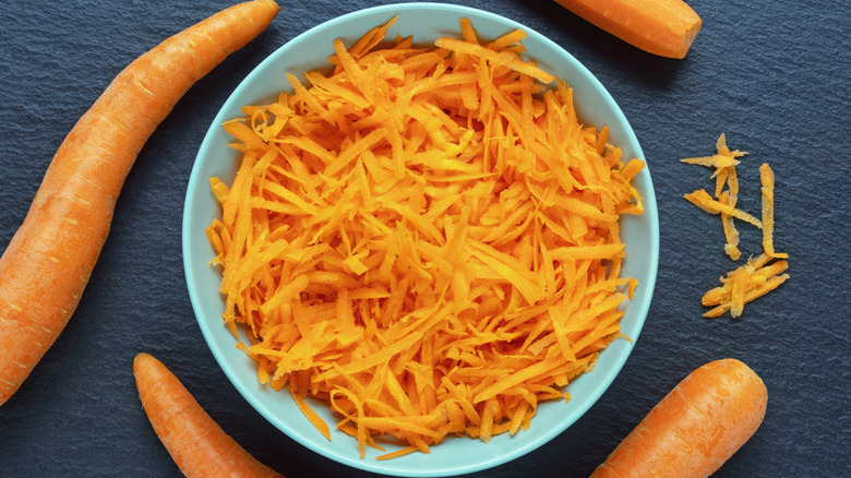 Grated carrots in light blue bowl