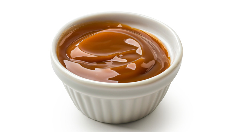 Melted caramel sauce in white bowl