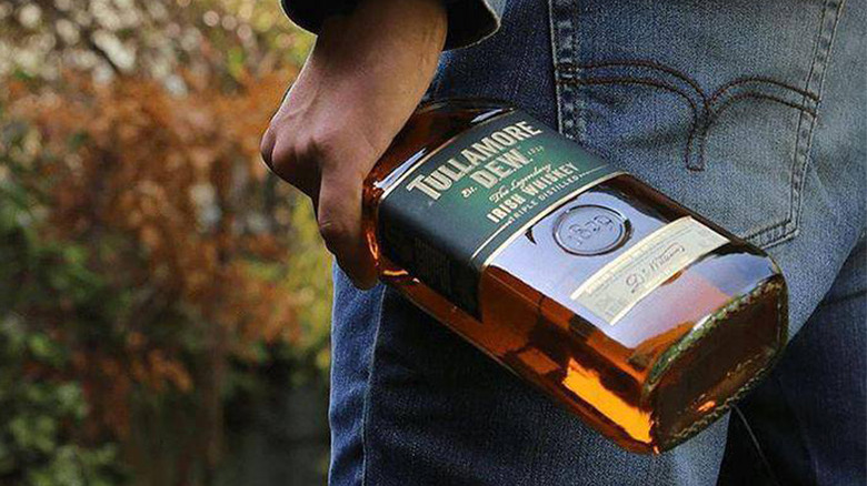 Person holding Tullamore Dew bottle