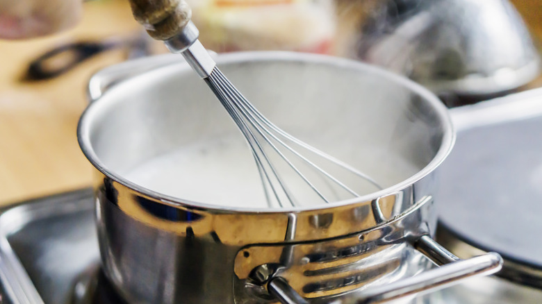 Whisking milk in pot