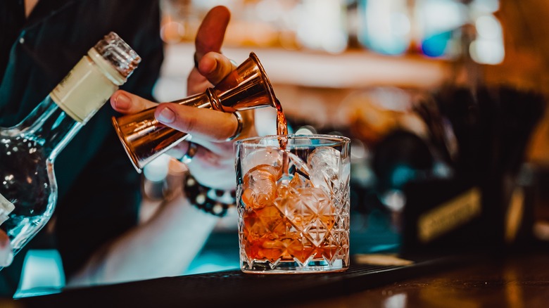 Bartender pouring bitters