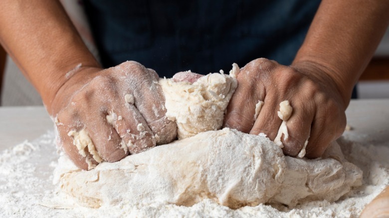 Hands kneading pasta dough
