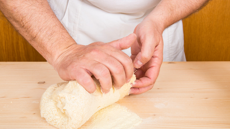 Hands kneading gnocchi dough