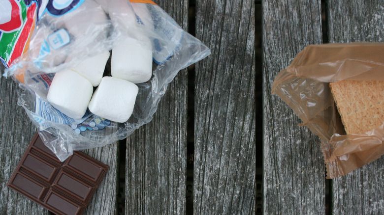 s'more ingredients on wooden surface