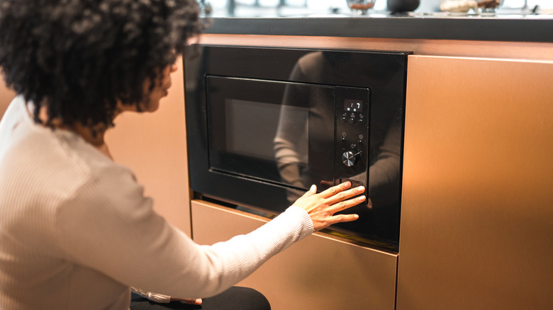 Woman using her microwave