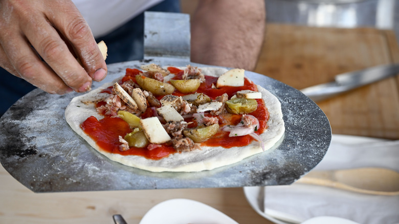 Adding toppings to a pizza