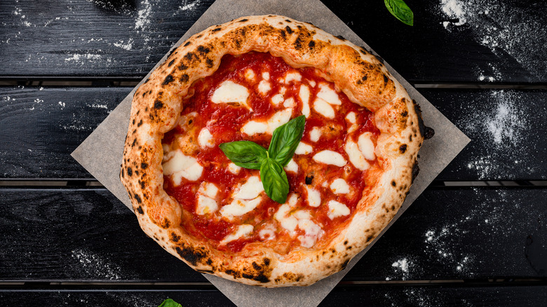 A margherita pizza on table