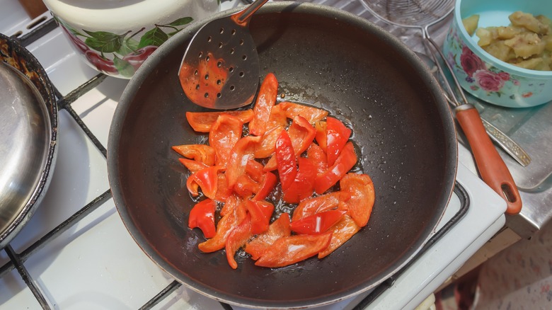 Red bell peppers in pan