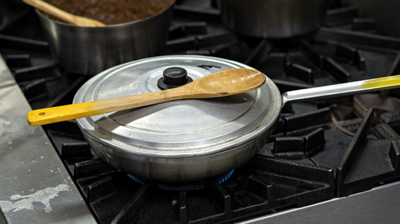 Lid on frying pan, stove