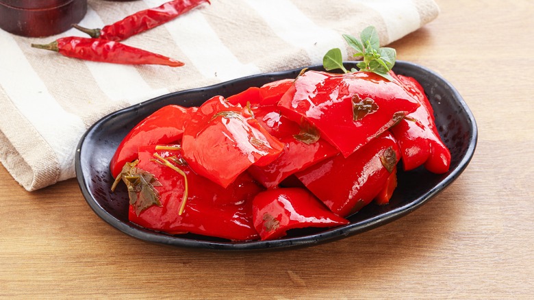 Oiled red peppers, black dish