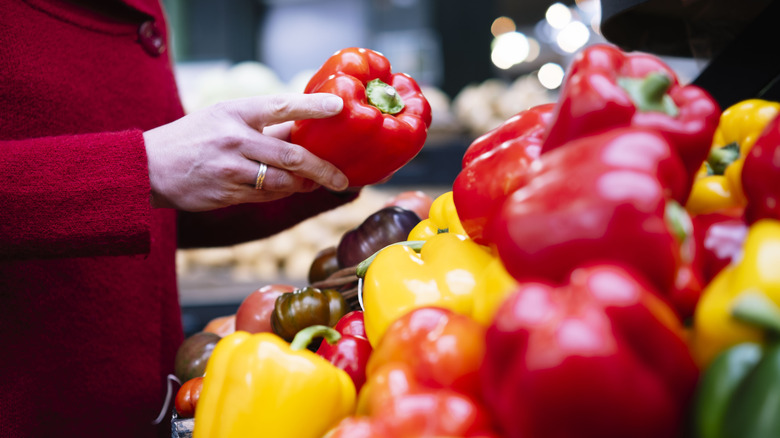 Person holding red bell pepper