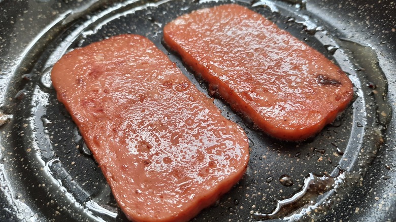 Spam cooking in oily pan