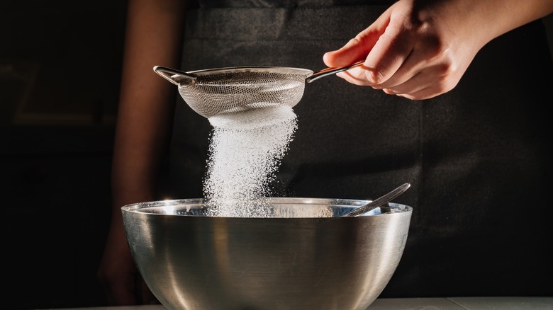sugar sifting into bowl