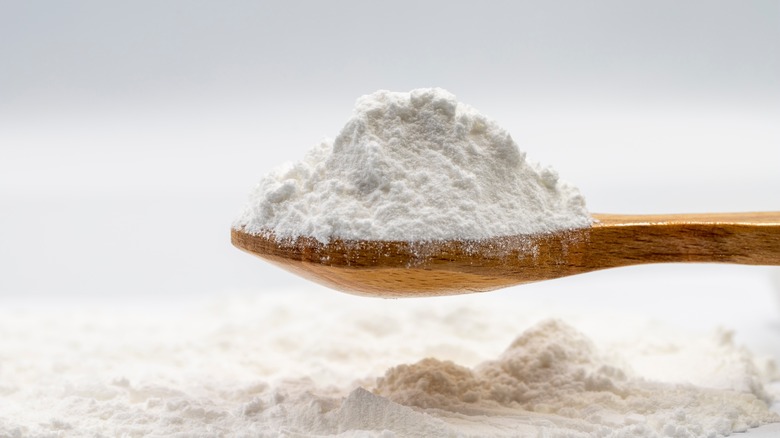 powdered sugar on wooden spoon