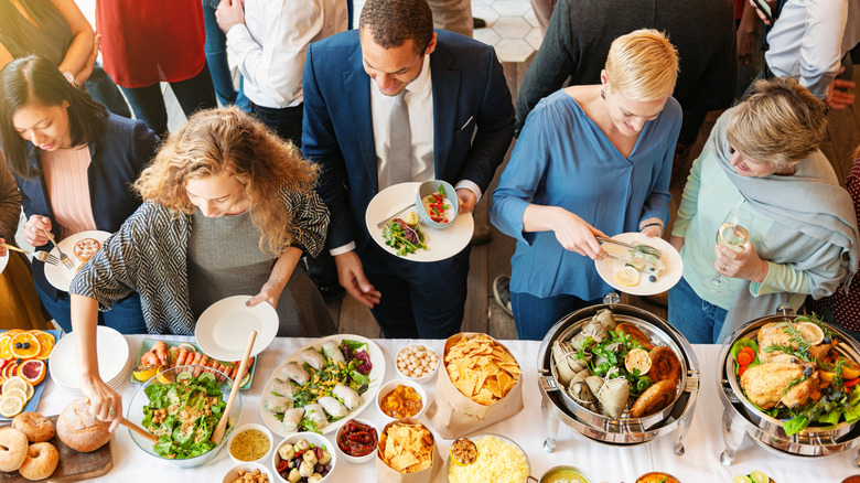 Several people using a buffet