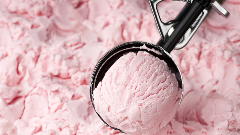 Scooping strawberry ice cream